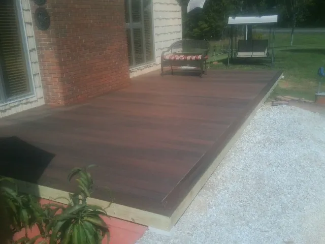 Freshly stained wood deck built against a brick home in Valley Lee
